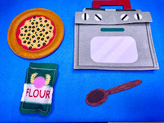 Felt pieces of pizza, oven, flour bag, and wooden spoon