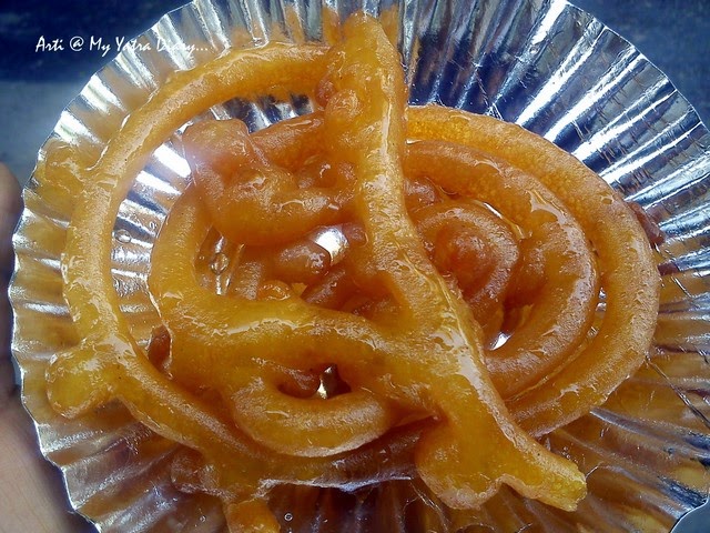 A piece of hot and juicy sweet jalebi at Old famous Jalebiwala - Chandni Chawk street food, Delhi