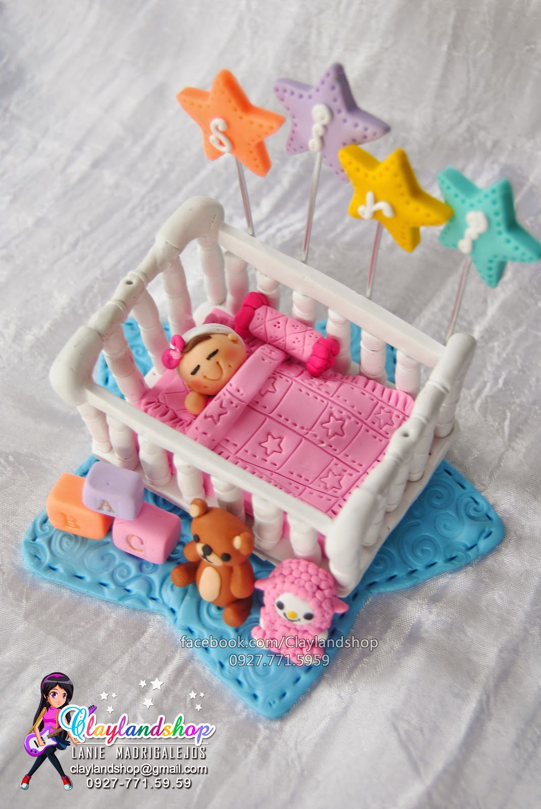 Clayland Souvenir Shop Baby sleeping in a crib cake topper