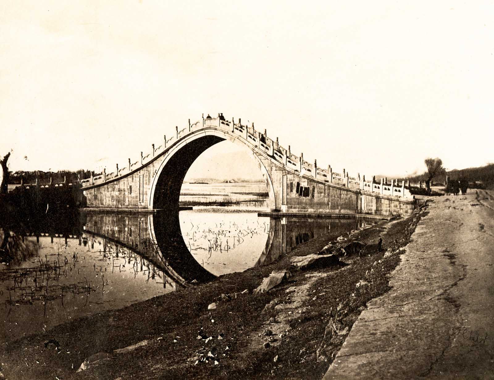 A view of Jade Belt Bridge, which still stands on the grounds of the Summer Palace on the western shore of Kunming Lake. The arched bridge, a traditional Chinese design, permitted passage of the Emperor’s dragon boat.