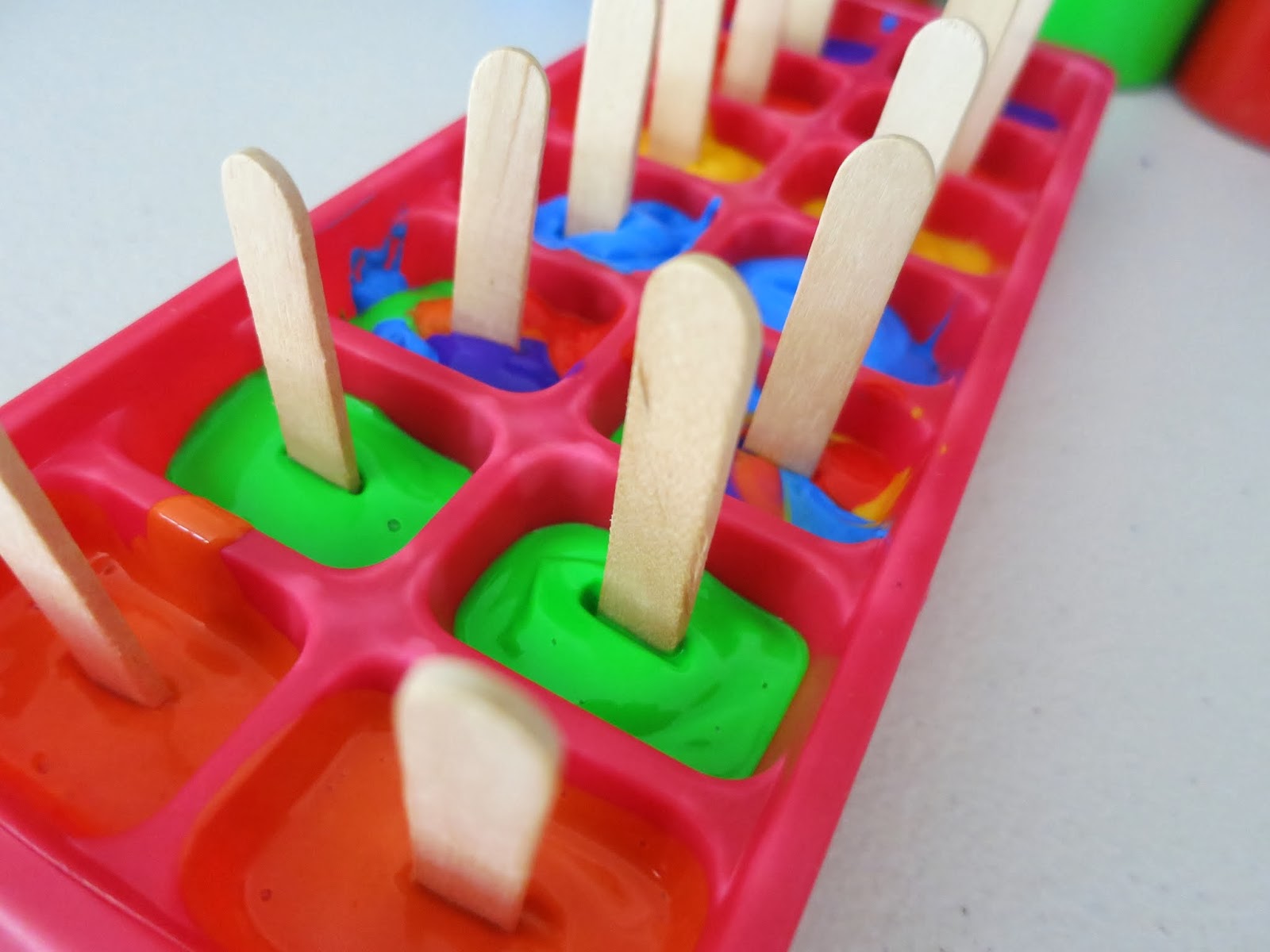 Learn with Play at Home Paintsicles. Frozen paint cubes for creative fun.