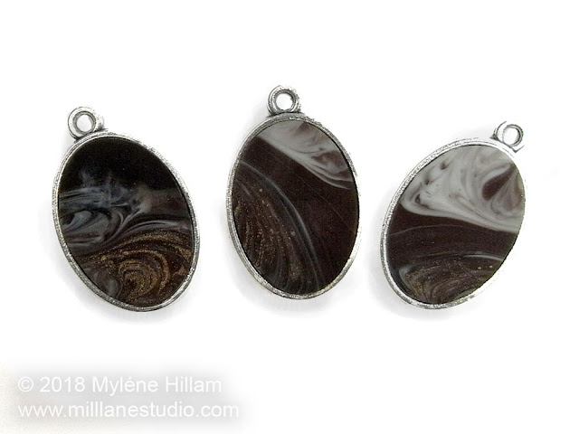 Trio of black, brown, gold and white marbled resin pendants