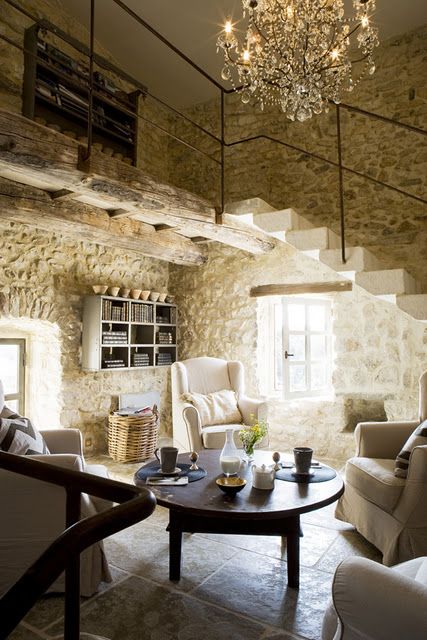 Exquisite limestone walls in #Frenchfarmhouse with delicate iron railing on stone steps and crystal chandelier on Hello Lovely Studio