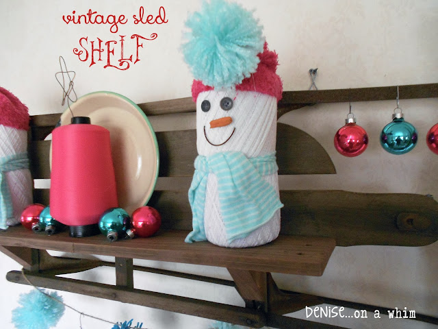 A vintage sled turned shelf decked out in teal and pink for Christmas via http://deniseonawhim.blogspot.com
