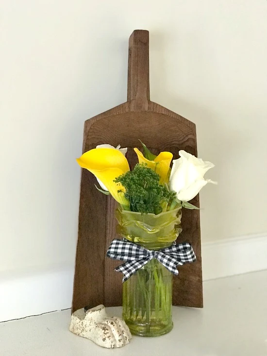 Faux depression glass flower vase and wooden scoop