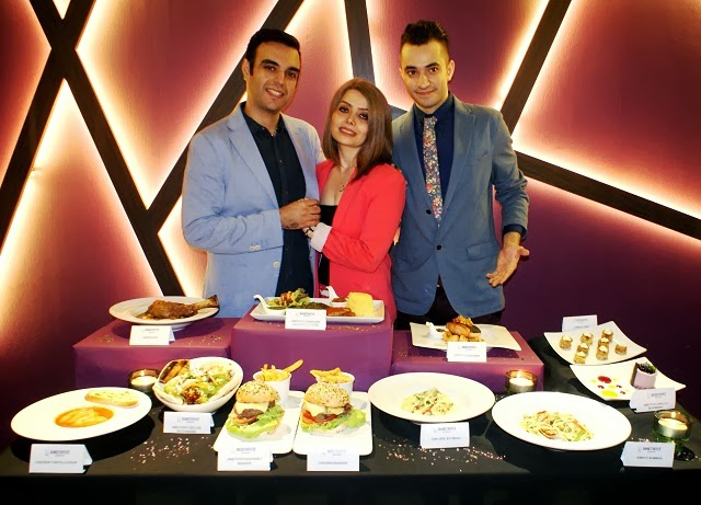 The Amethyst Restaurant founders with a full display of their signature dishes