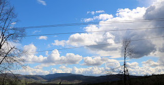 Some fluffy looking clouds, with a storm bubbling up as well Some fluffy looking clouds, with a storm bubbling up as well