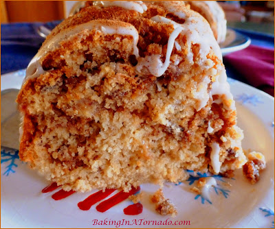 Sweet Potato Pecan Cake with Maple Glaze, a moist holiday cake with a hint of sweet potato, a cinnamon ,maple swirl center and a hint of maple maple in the glaze. | Recipe developed by www.BakingInATornado.com | #recipe #cake #holiday