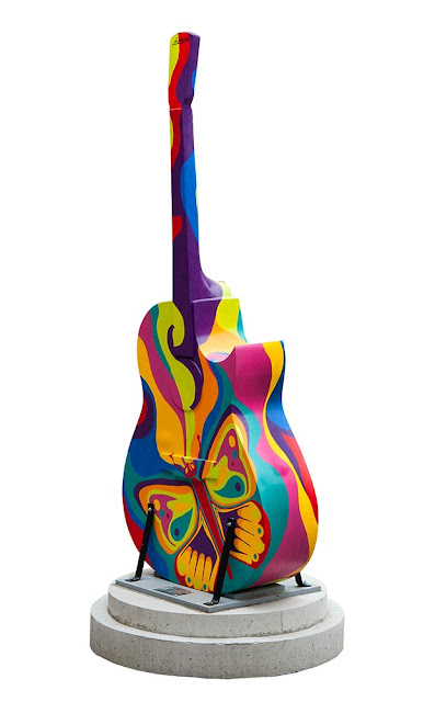 downtown Orillia painted guitar display, multicoloured design on guitar with painted butterfly