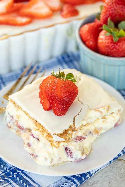 Strawberries and Cream Eclair Cake - delicious no-bake dessert! Vanilla pudding, cool whip, strawberries and graham crackers layered and topped with vanilla frosting. It gets better the longer it sits in the fridge - it is just SO hard to wait to eat it. SOOO good. People go nuts over this easy dessert recipe! #dessert #cake #nobake Strawberries and Cream Eclair Cake - delicious no-bake dessert! Vanilla pudding, cool whip, strawberries and graham crackers layered and topped with vanilla frosting. It gets better the longer it sits in the fridge - it is just SO hard to wait to eat it. SOOO good. People go nuts over this easy dessert recipe! #dessert #cake #nobake