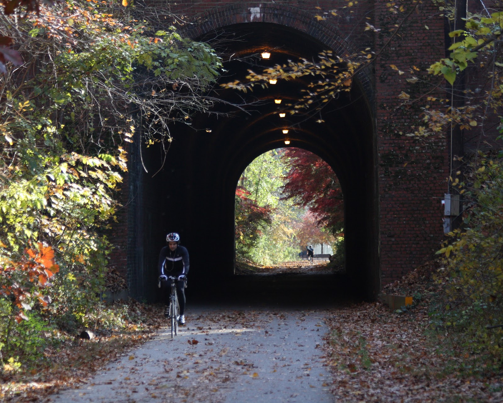 Rider bicycling through tunnel