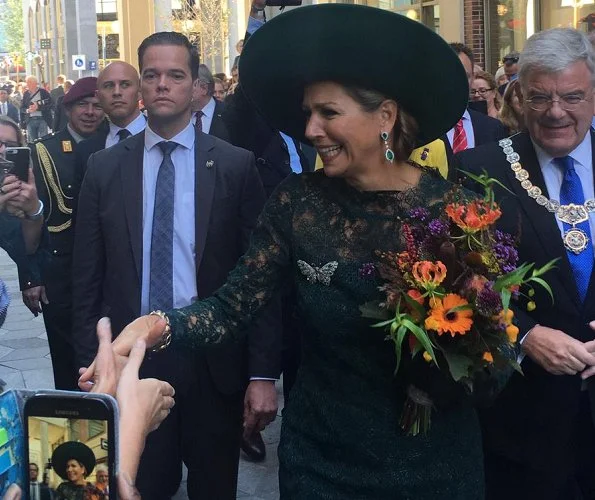 Dutch Queen Máxima attended Leidsche Rijn's 20th anniversary celebrations. Queen wore a green lace dress and pumps by Natan. diamond earrings