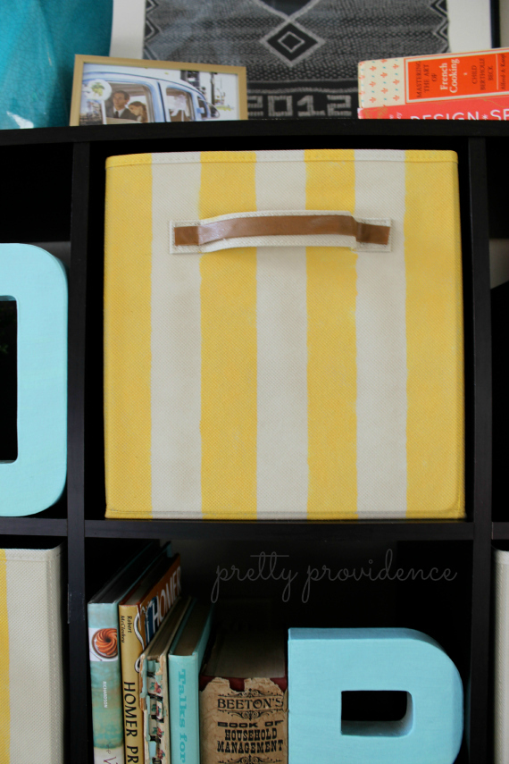 give your plain storage bins a quick makeover with a little bit of paint! candy striped bins DIY by pretty providence
