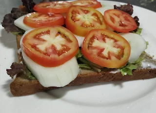 Cucumber tomato slice over lettuce mayonnaise bread for veg club sandwich recipe