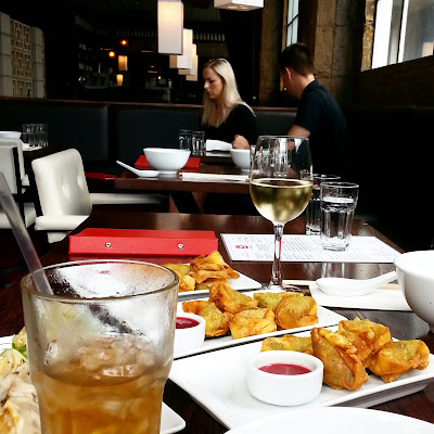 Restaurant table with drinks and food on it.