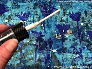 How to use a spray bottle to create spatters on an art journal page