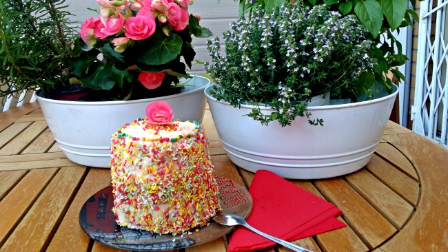 Una tarta pequeña y alta decorada con caramelos de chocolate