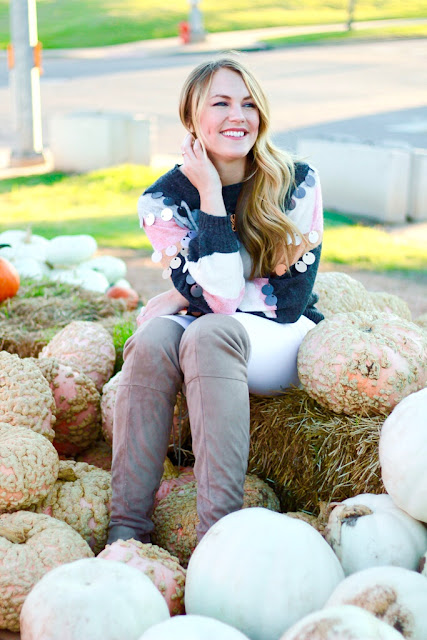 Girl wearing a tassel sweater in pumpkin patch
