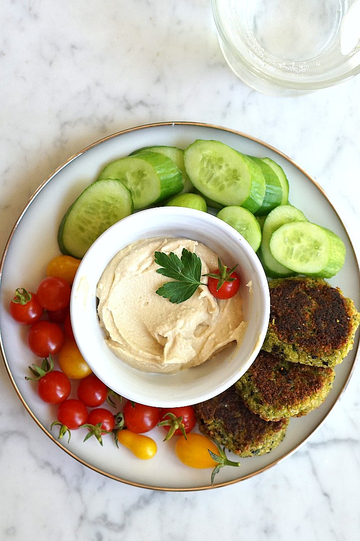Homemade falafel Vegan falafel served with cucumber, tomatoes, and hummus.