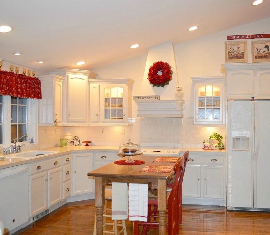 White/ Bisque  cottage style kitchen with red accents and wooden island