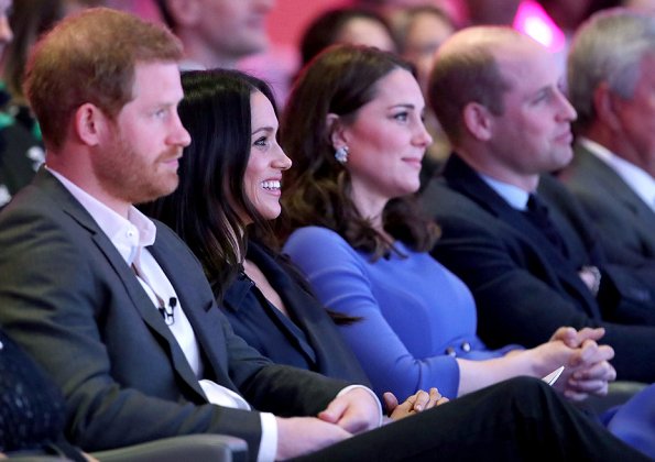 Meghan Markle wore Jason Wu Flared Belted Satin Dress. Kate Middleton wore Seraphine Royal Blue Tailored Maternity Dress. Prince Harry