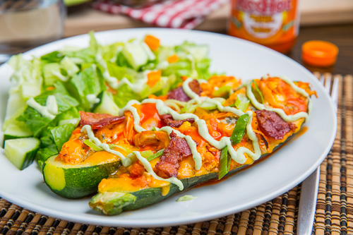 Buffalo Chicken Stuffed Zucchini topped with Melted Cheddar, Bacon and an Avocado Blue Cheese Dressing Buffalo Chicken Stuffed Zucchini topped with Melted Cheddar, Bacon and an Avocado Blue Cheese Dressing