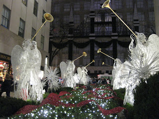 Angels with trumpets, lit at night, Rockefeller Center, New York, New York