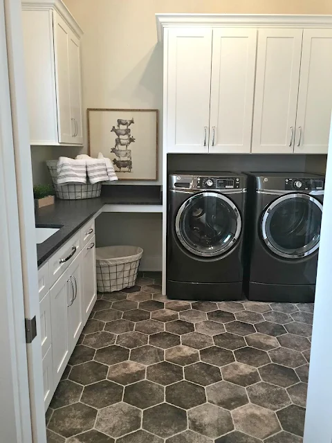 dark hexagon tiled floor in laundry