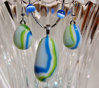 Necklace and earrings created from fused glass puddles