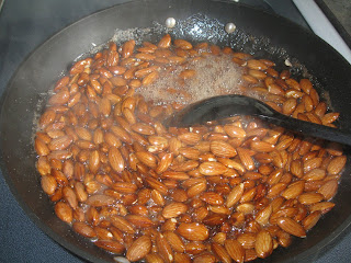 Stirring almonds in a pan on a stove