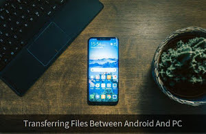 A smartphone and a laptop on a wooden table