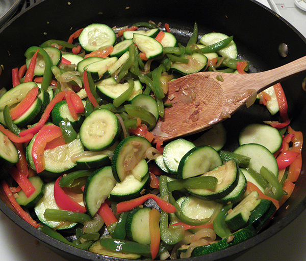 Skillet with bell peppers and aromatics, and zucchini