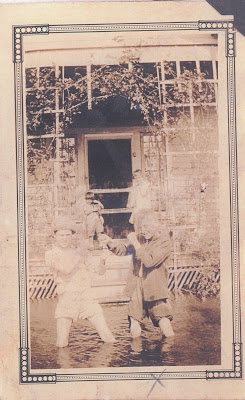 Frederick "Freddie" Killman, René Alberta, Ida Killman, and Dororthy Killman play in the flood waters caused by the Great Mississippi River Flood of 1927