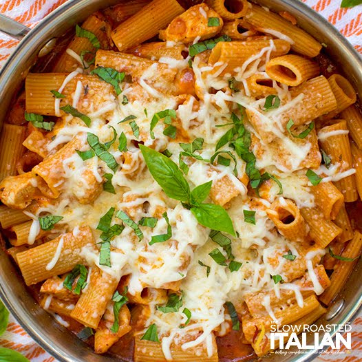 Chicken Parmesan Pasta (One Pan Meal) close up image of skillet meal with Italian chicken on bed of penne pasta