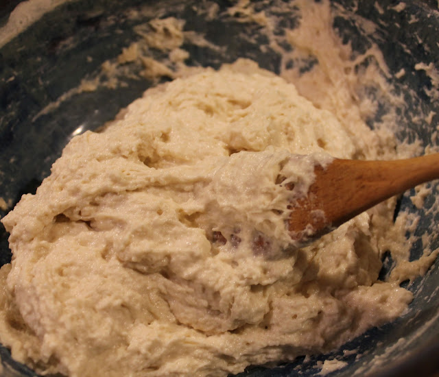 Mix the no-kneed bread dough with a wooden spoon. Mixing No-Knead Bread