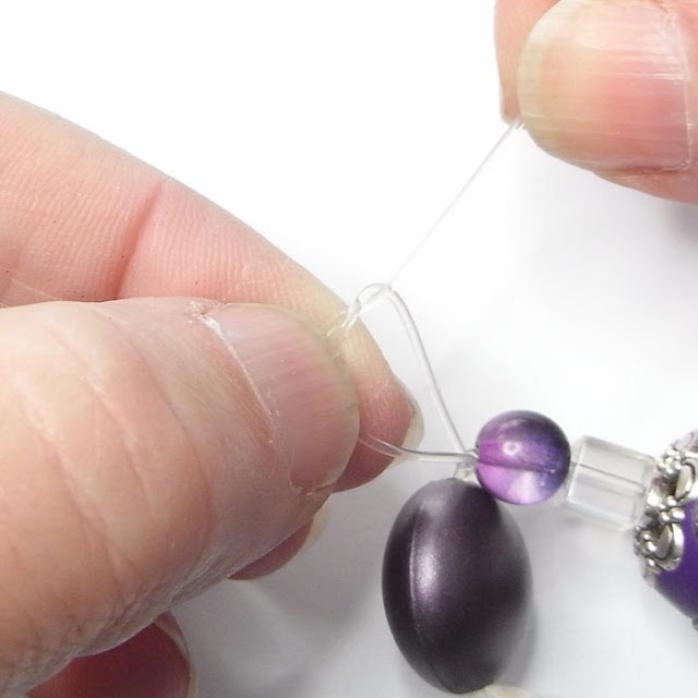 Tying a double knot in beading elastic