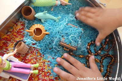 A beach and underwater themed sensory tub for children