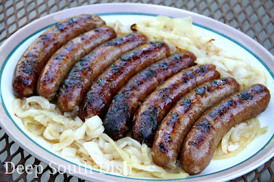 Bratwurst sausage, braised on the grill in a hot tub of beer, onions and butter, then seared and returned to the tub. Serve on hard rolls, with mustard, onions and pickles.