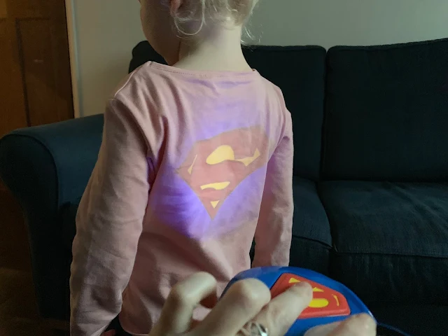 Projection of the Herodrive Superman Signal Squad Cars on to a toddlers back