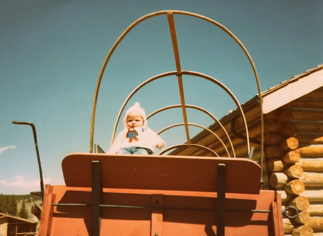 baby claire in a covered wagon in wyoming