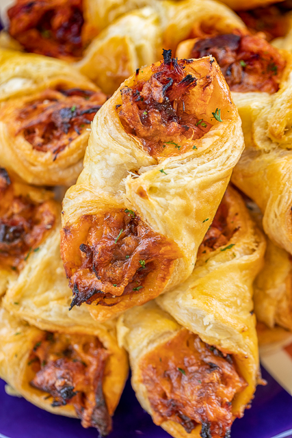 Pulled Pork Pastry Puffs - only 4 ingredients! Great recipe for a quick lunch, dinner or party. Smoky pulled pork tossed with BBQ sauce and cheese then baked in puff pastry. SO good! Can make ahead and freeze for later. We love to serve these with some coleslaw and extra BBQ sauce or Ranch for dipping. YUM! #pulledpork #partyfood #appetizer #tailgating Pulled Pork Pastry Puffs - only 4 ingredients! Great recipe for a quick lunch, dinner or party. Smoky pulled pork tossed with BBQ sauce and cheese then baked in puff pastry. SO good! Can make ahead and freeze for later. We love to serve these with some coleslaw and extra BBQ sauce or Ranch for dipping. YUM! #pulledpork #partyfood #appetizer #tailgating