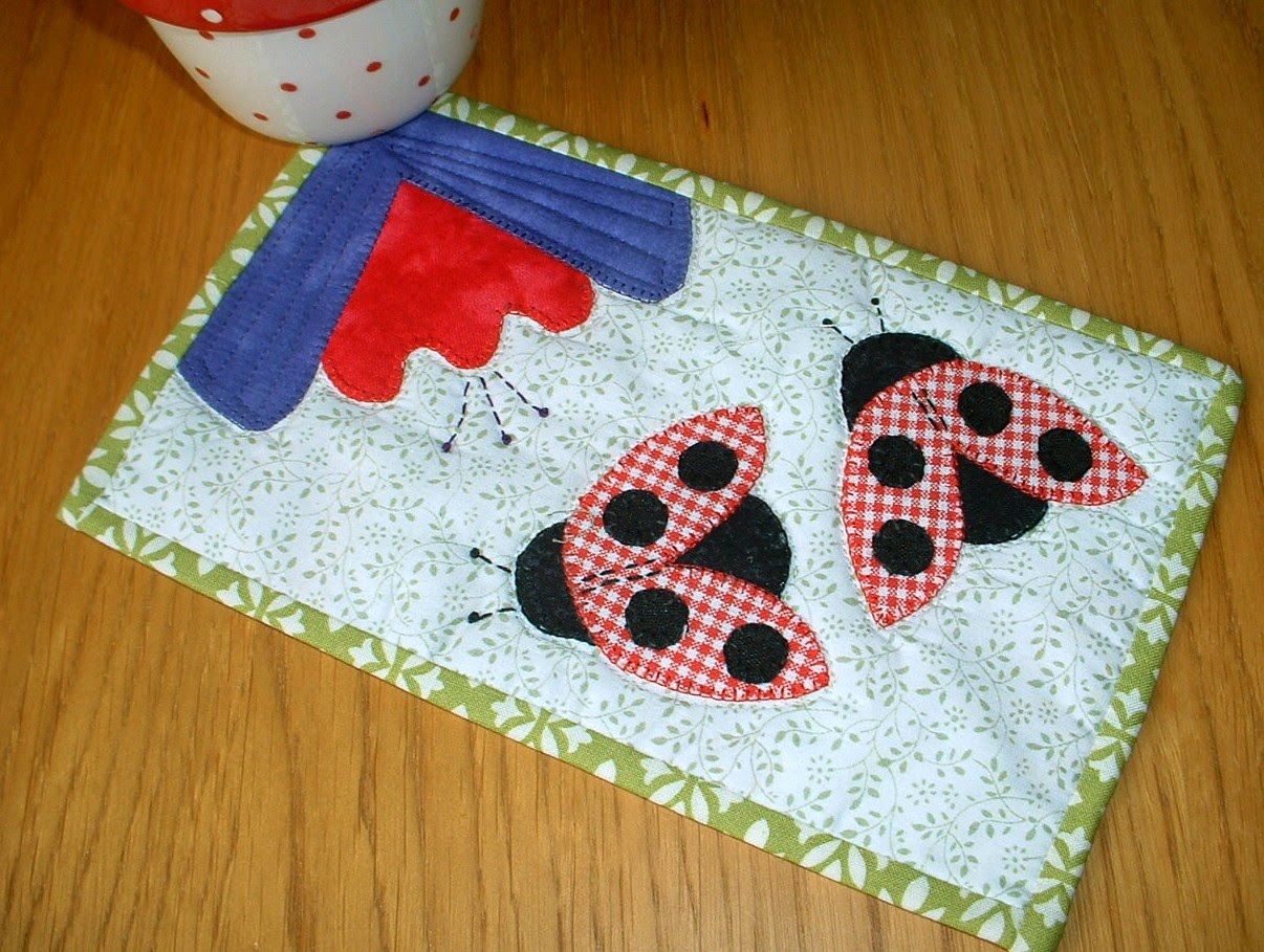 http://www.craftsy.com/pattern/quilting/home-decor/ladybugladybird-mug-rug/57620