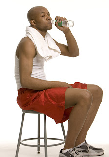 guy rehydrating with water after workout