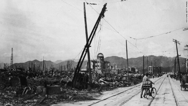 20 Shocking Pictures Of Hiroshima, The First City In History To Be Destroyed By An Atomic Bomb - A man on a bike crossing the destroyed Hiroshima, a few days after the first atomic bomb was dropped.