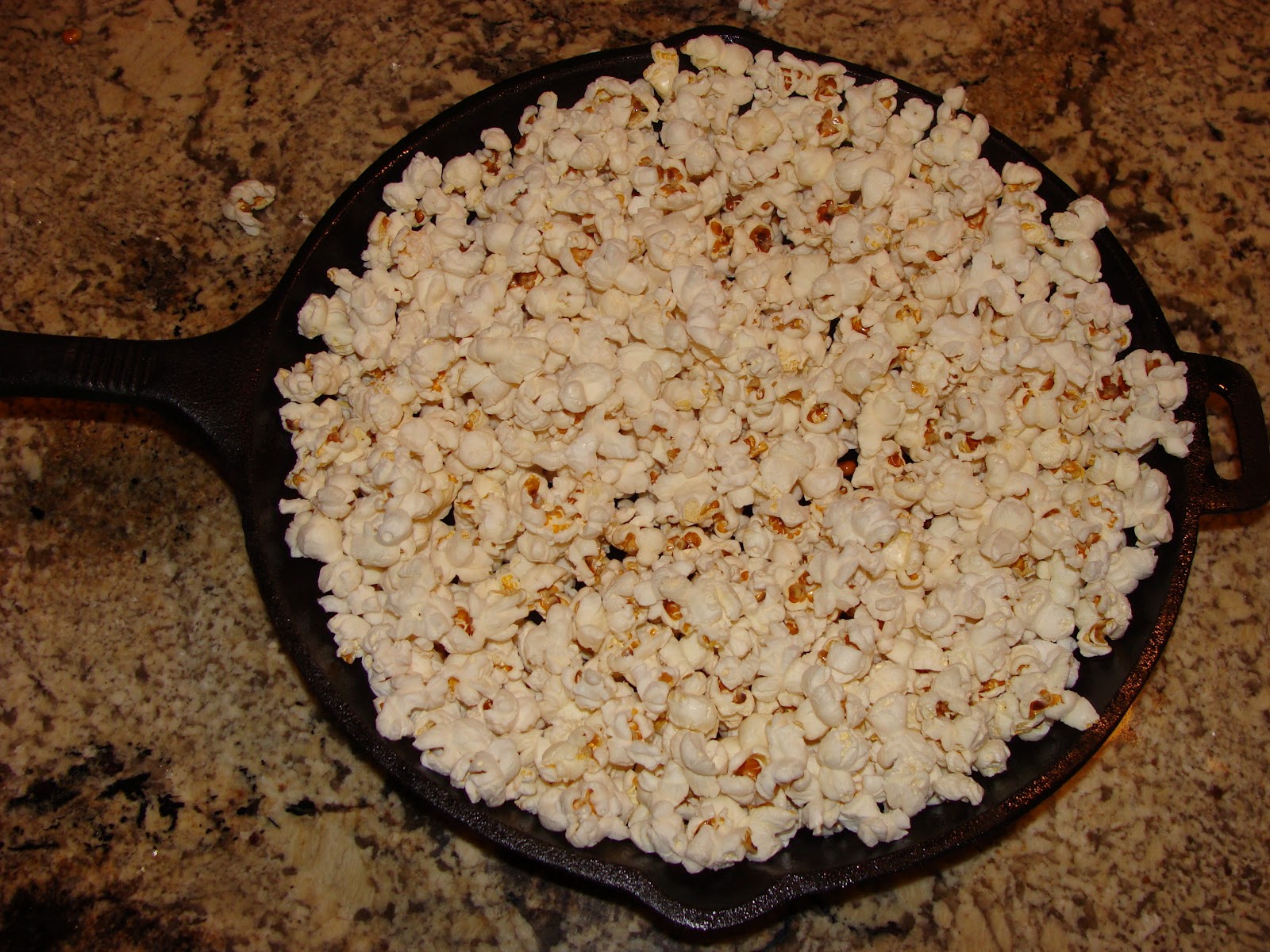 Iron Pot Cooking Popping Popcorn in Cast Iron