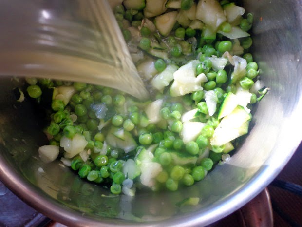 Stir in the peas, pour on the hot stock