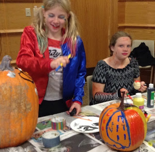 teens paint pumpkins