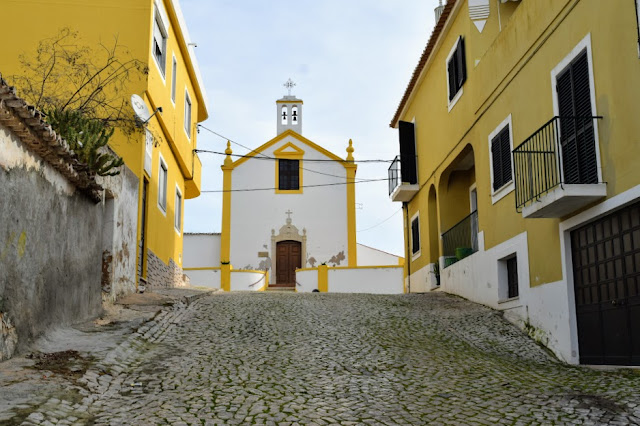 Looking up to a back street chapel in Alcantarilha, Portugal | The Chapel Of Bones, Alcantarilha, Portugal