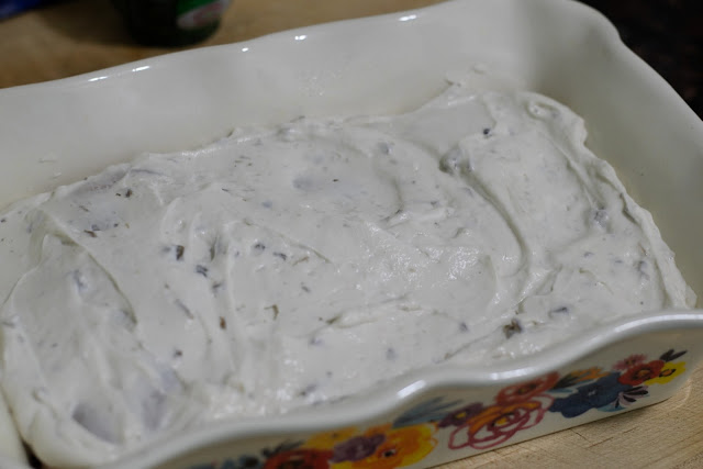 The cream mixture spread over the uncooked chicken in the baking dish. 