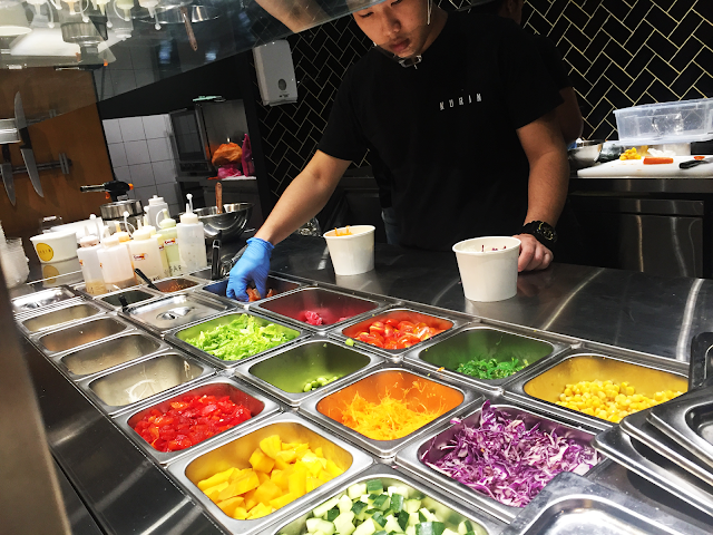 staff in action preparing the sushi bowl